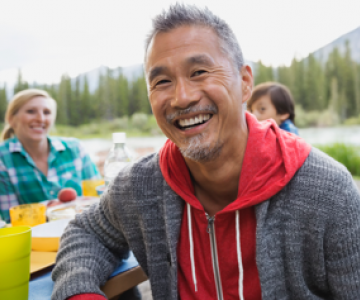 Man smiling at picnic table